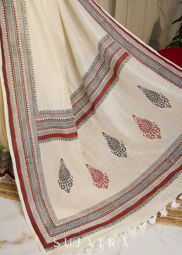 Ethereal off-white saree adorned with exquisite hand block prints and intricate artwork