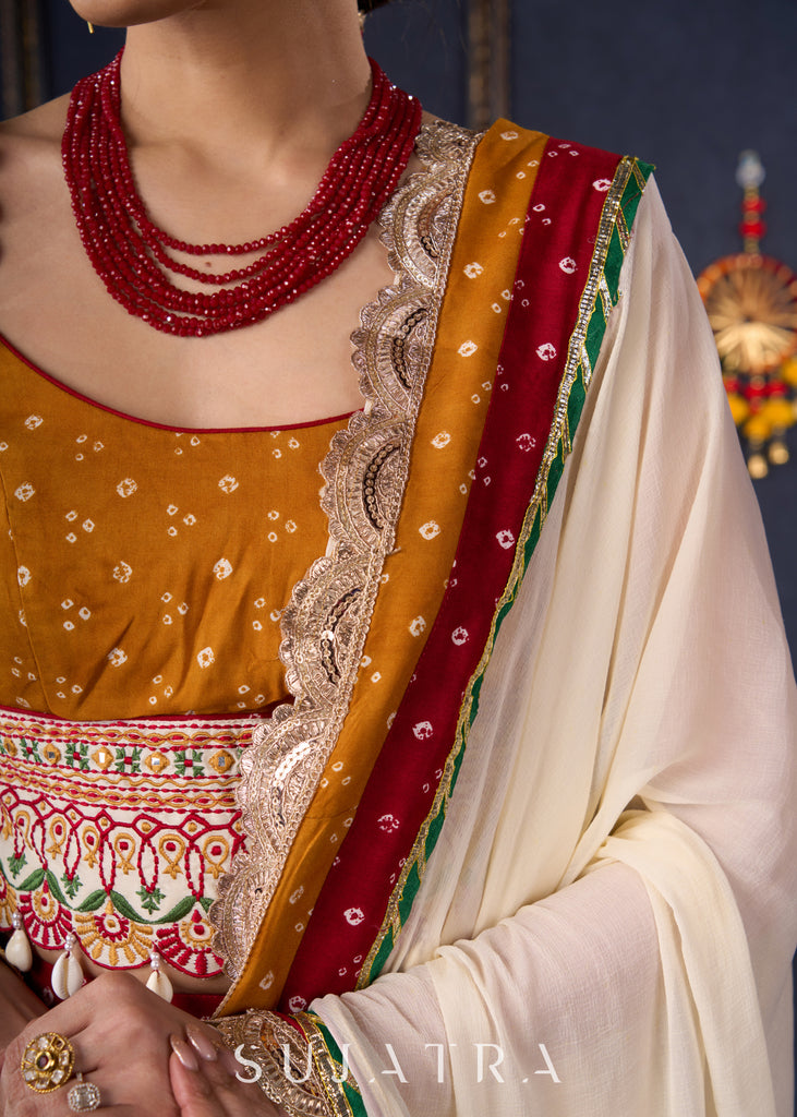 Beautiful Red Bandhani Lehenga With Mustard Embroidered Blouse & Matching Dupatta.