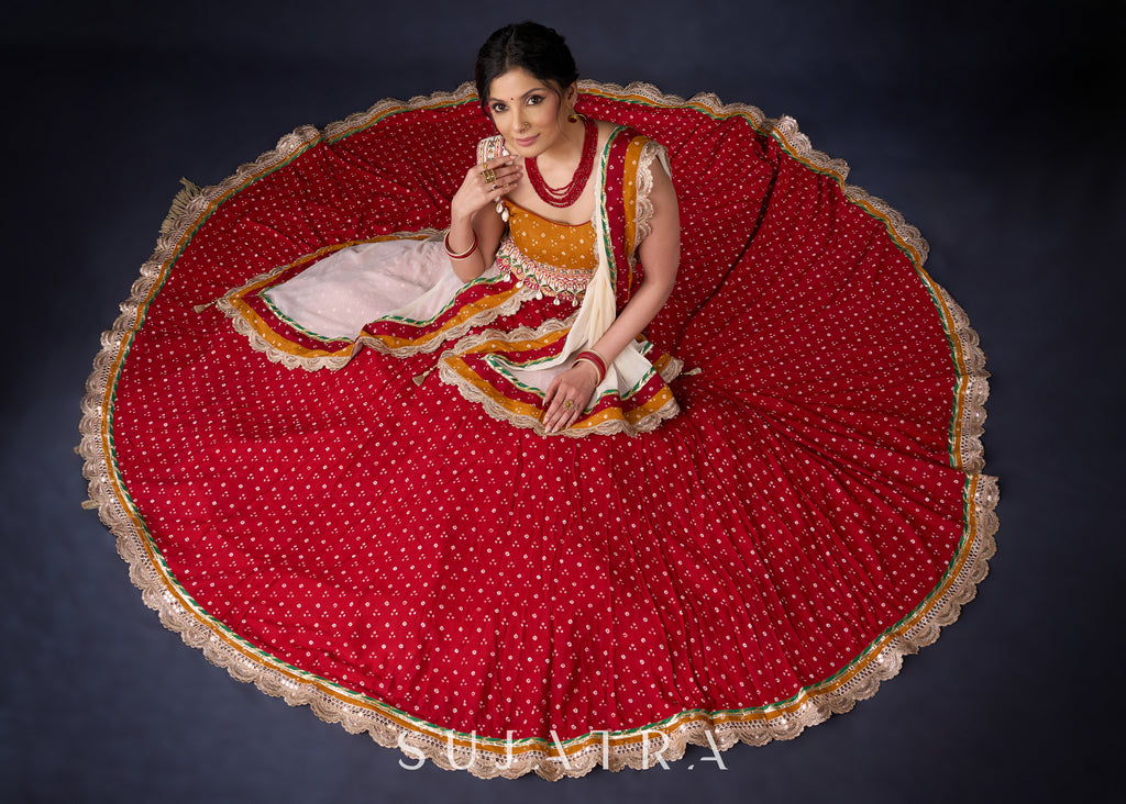 Beautiful Red Bandhani Lehenga With Mustard Embroidered Blouse & Matching Dupatta.