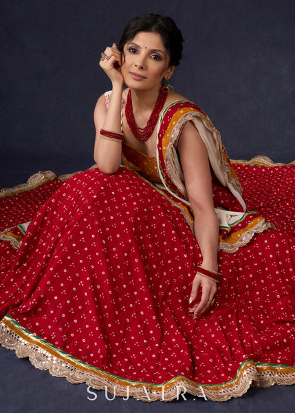 Beautiful Red Bandhani Lehenga With Mustard Embroidered Blouse & Matching Dupatta.