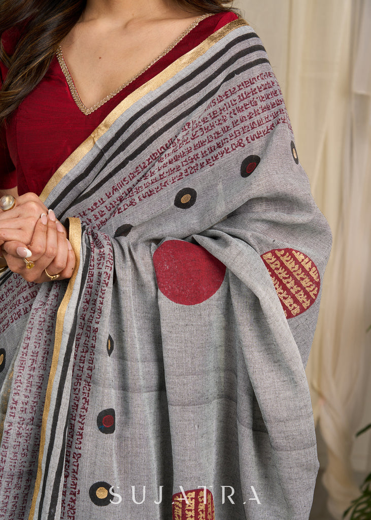 Graceful grey cotton saree adorned with intricate block prints and captivating mantra details