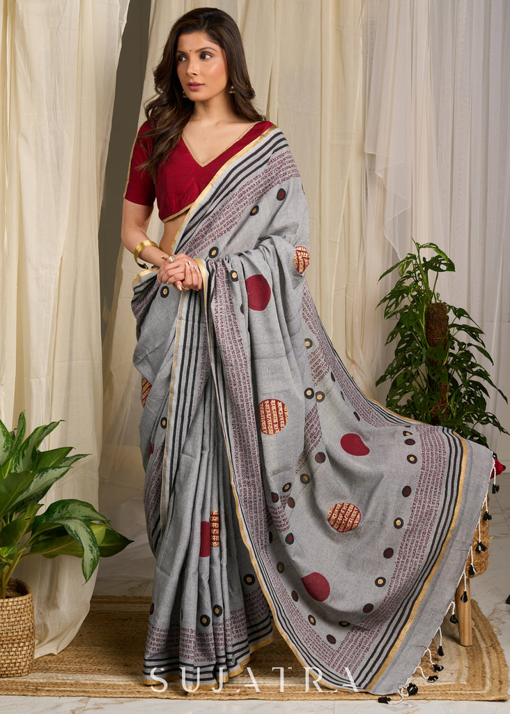 Graceful grey cotton saree adorned with intricate block prints and captivating mantra details