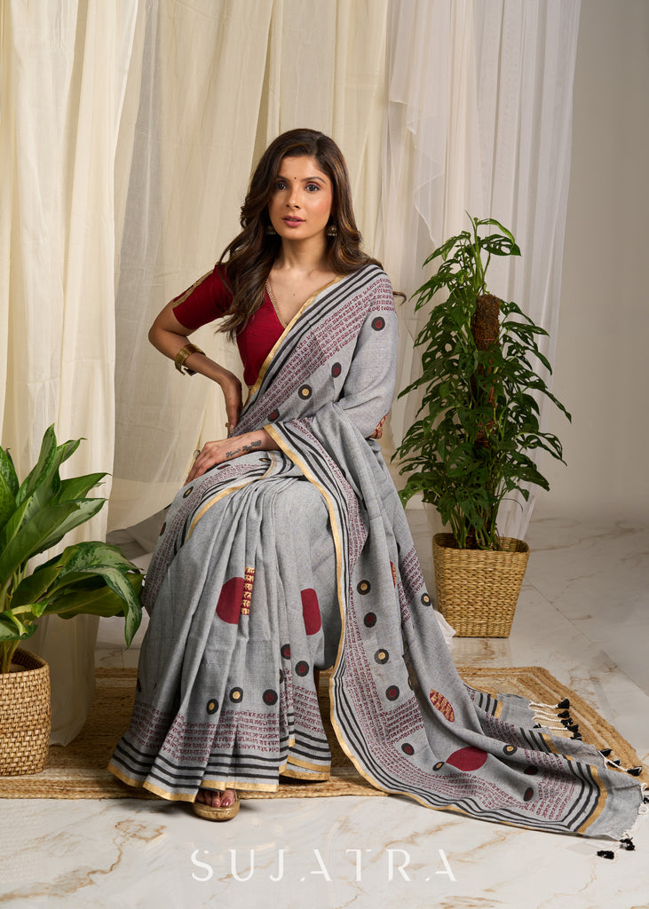 Graceful grey cotton saree adorned with intricate block prints and captivating mantra details