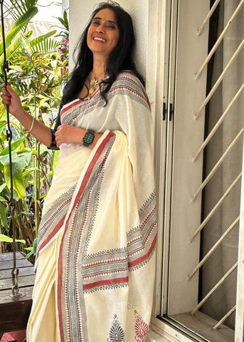 Ethereal off-white saree adorned with exquisite hand block prints and intricate artwork