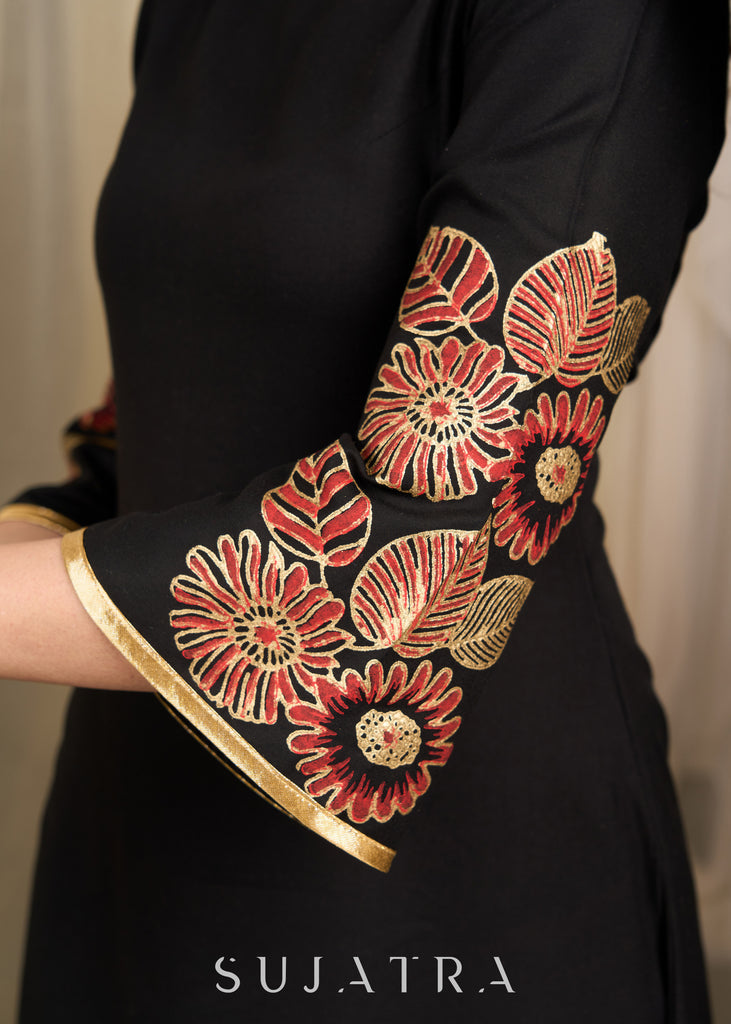 Classic black dress with vibrant floral block print and gold detailing