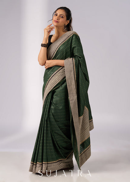 Elegant green cotton saree with intricate striped border & zari highlights