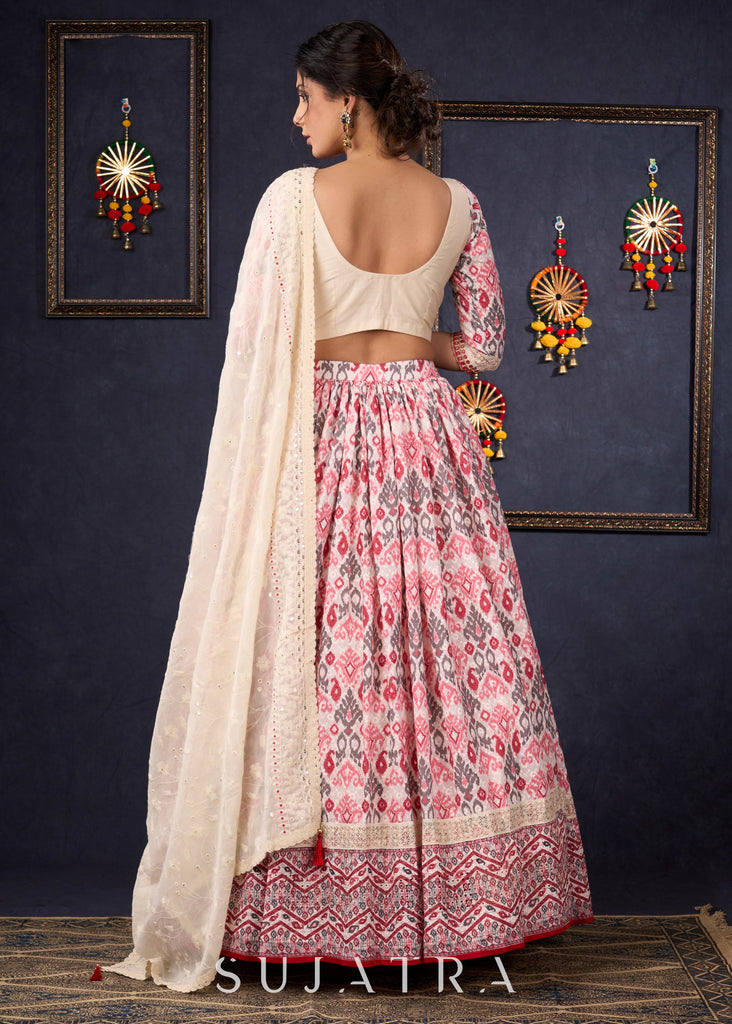 Elegant Off-White & Red Ikat Print Lehenga With Matching Blouse & Dupatta.