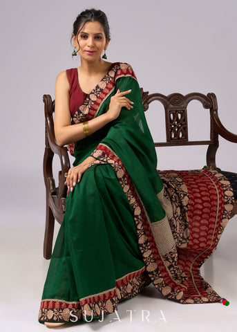 Stunning green cotton saree with beige and red floral Ajrakh accents