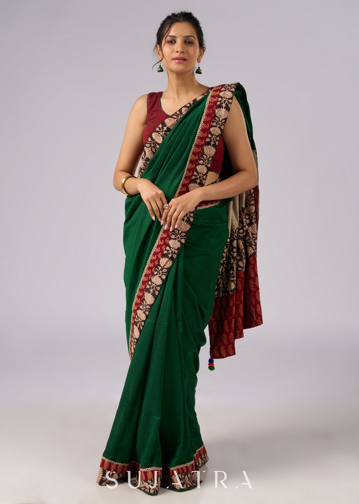 Stunning green cotton saree with beige and red floral Ajrakh accents