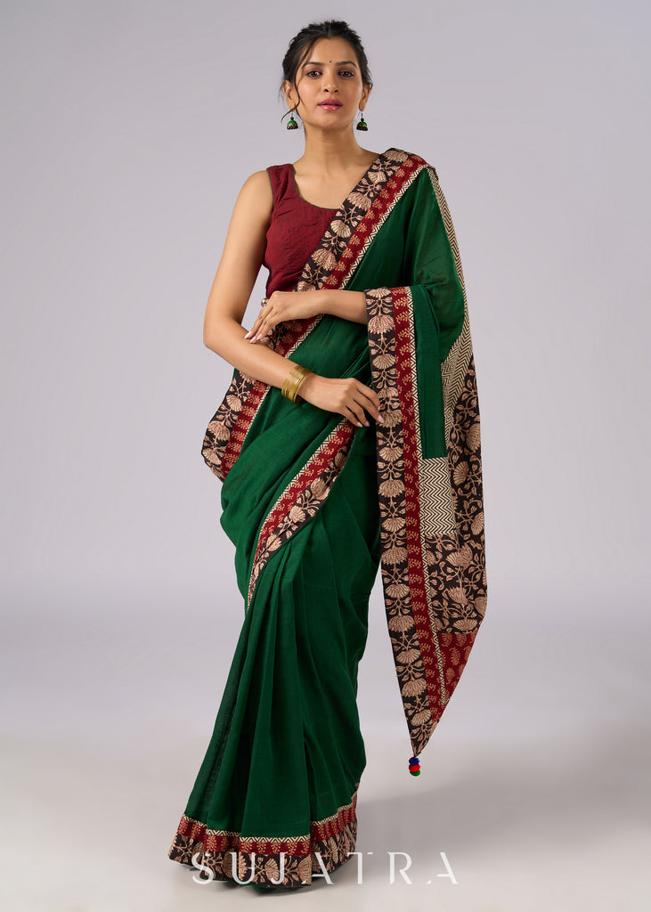 Stunning green cotton saree with beige and red floral Ajrakh accents