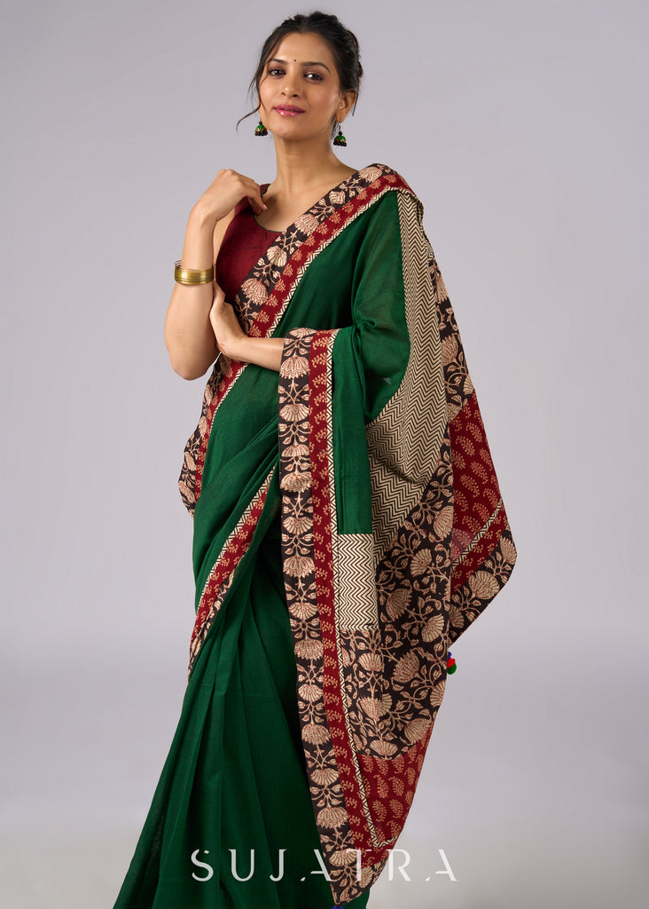 Stunning green cotton saree with beige and red floral Ajrakh accents