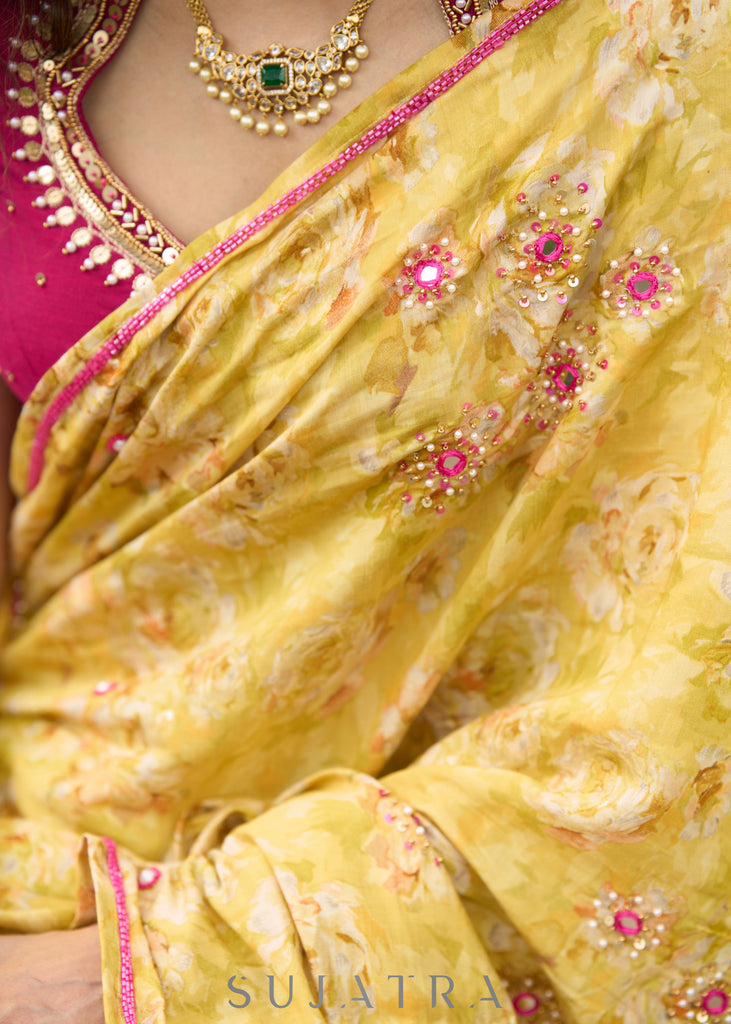 Graceful yellow floral print saree highlighted with overall beautiful hand embroidered mirrors