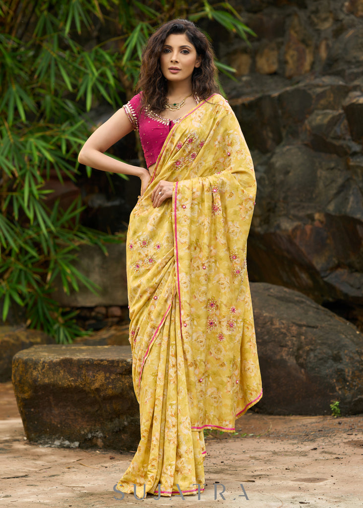 Graceful yellow floral print saree highlighted with overall beautiful hand embroidered mirrors