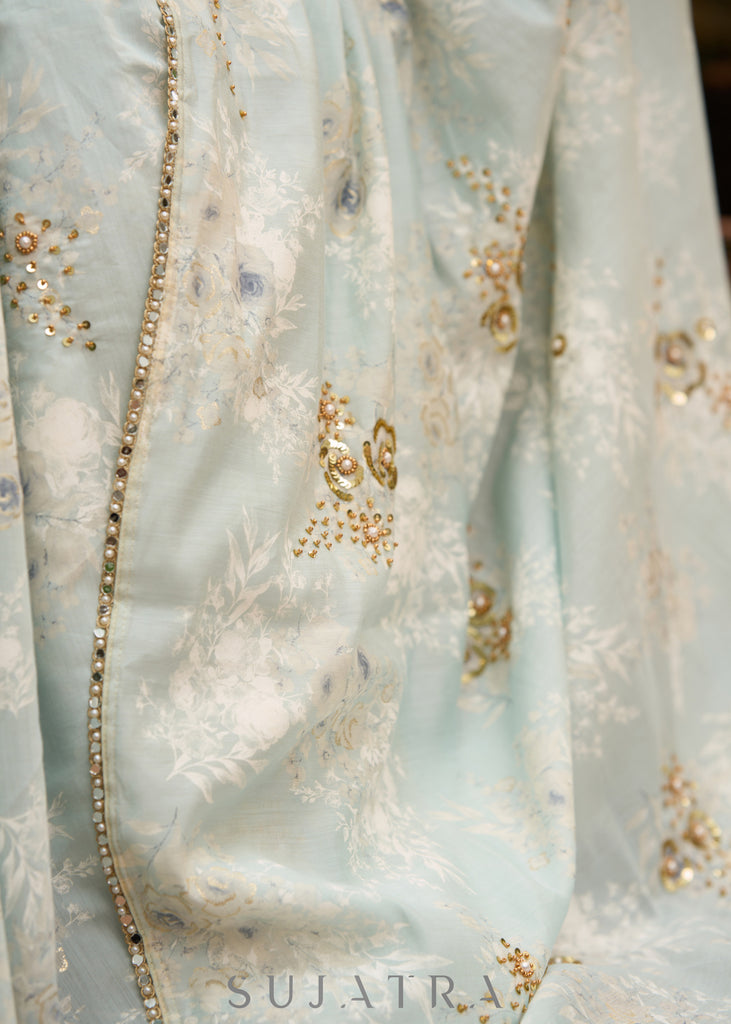 Stylish ice blue floral printed saree highlighted with beautiful golden embroidery