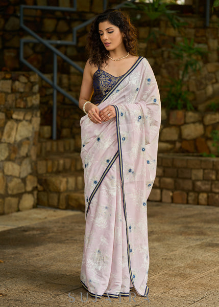 Subtle light pink floral embroidered saree highlighted with overall mirror embroidery and golden lace