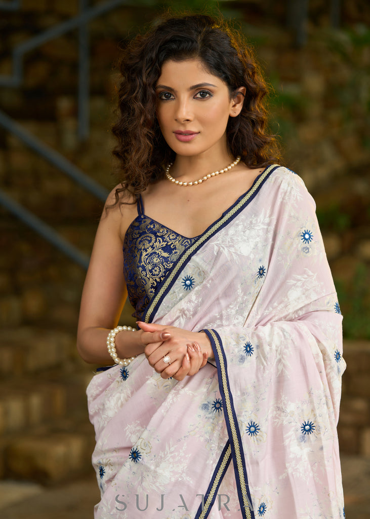 Subtle light pink floral embroidered saree highlighted with overall mirror embroidery and golden lace