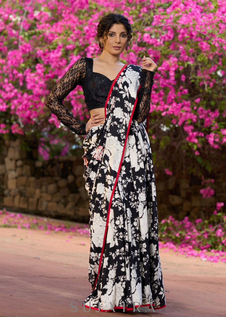 Trendy black floral printed cotton saree highlighted with overall bead embroidery