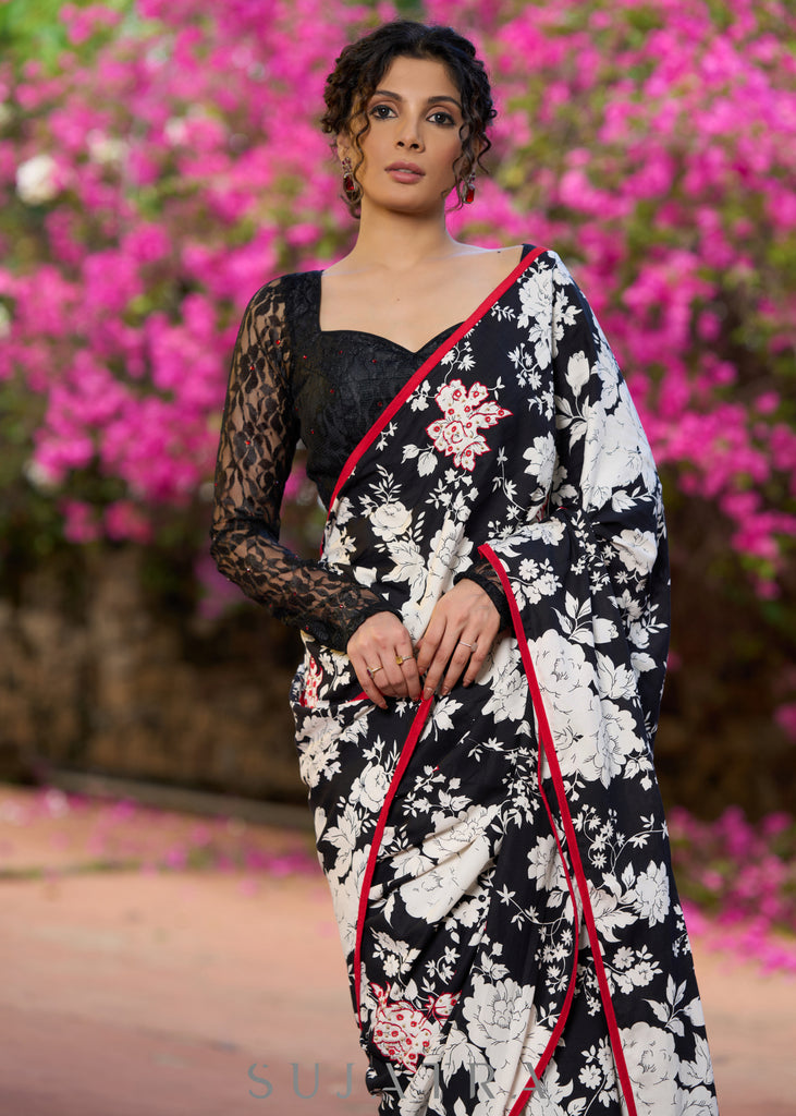 Trendy black floral printed cotton saree highlighted with overall bead embroidery