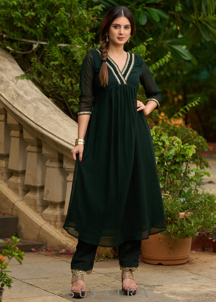 Elegance redefined in this captivating green georgette lace kurta and pant ensemble