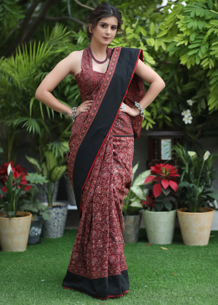 Sensuous maroon Ajrakh saree with black border & Accentuated with stone embellishment.