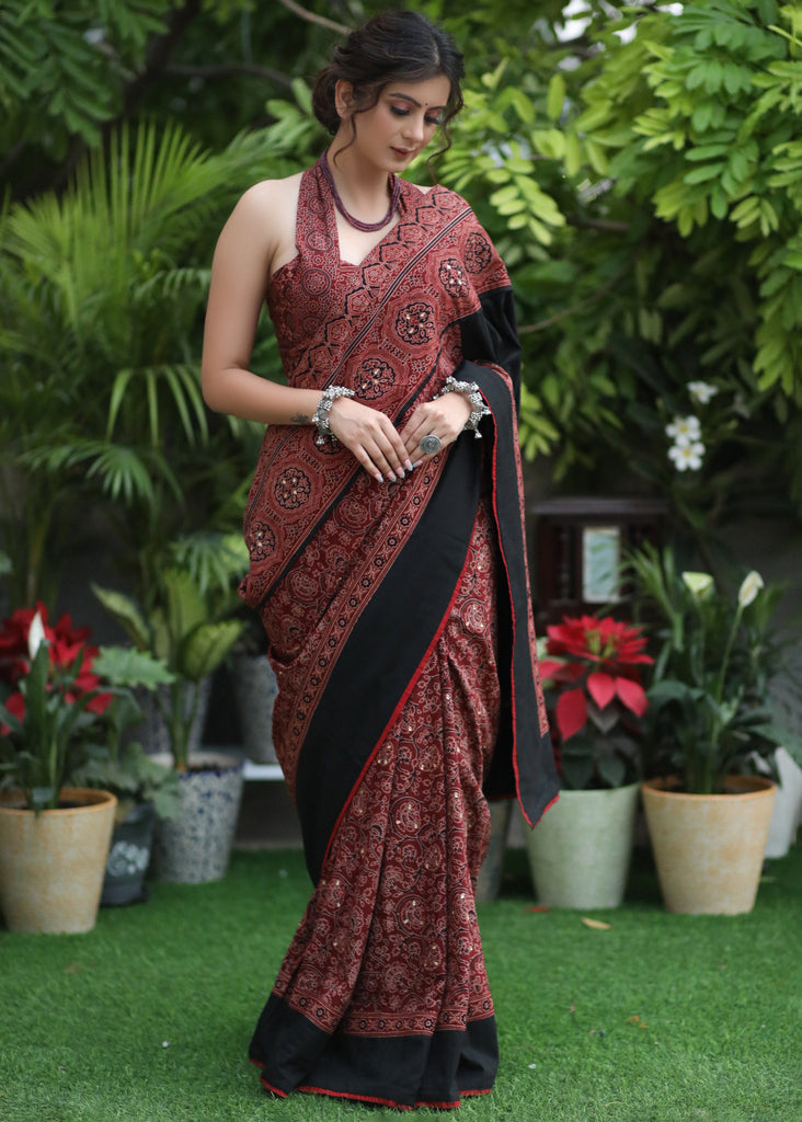 Sensuous maroon Ajrakh saree with black border & Accentuated with stone embellishment.