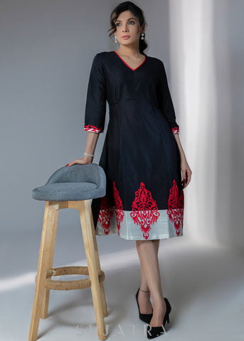 Black cotton silk dress with red embroidery motifs on hem